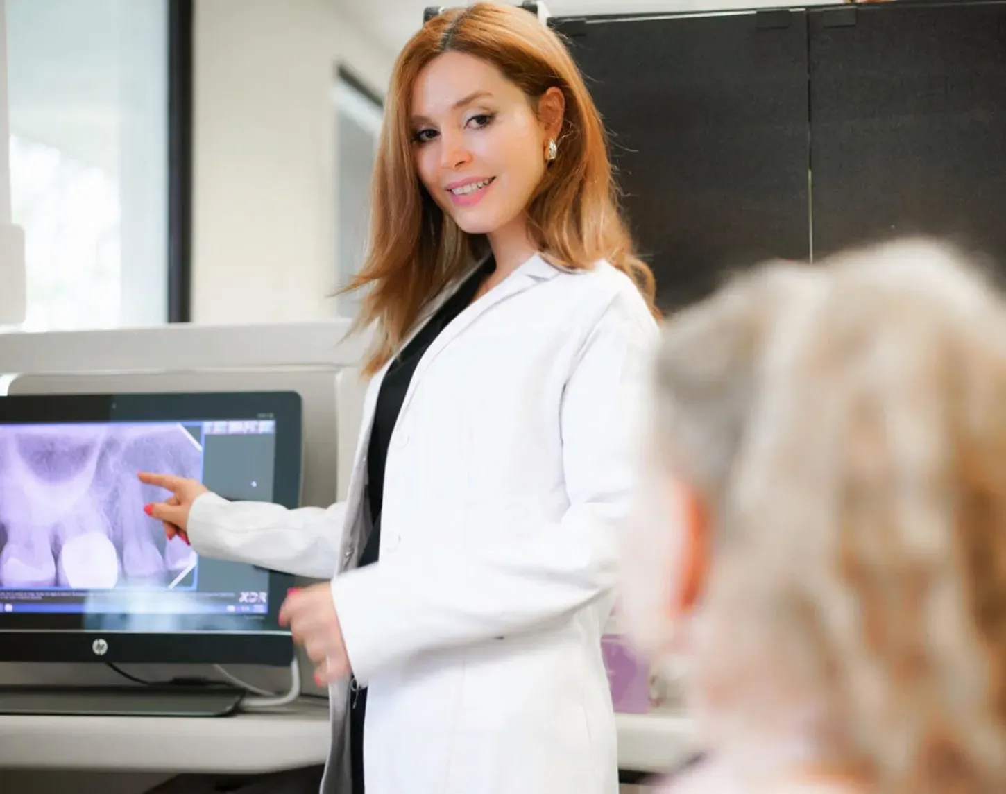 Dr. Maral reviewing an X-ray with a patient at Torrance Dental Spa